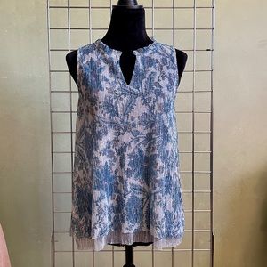 Unique sleeveless, double layer blouse with metallic sheen and rounded hem